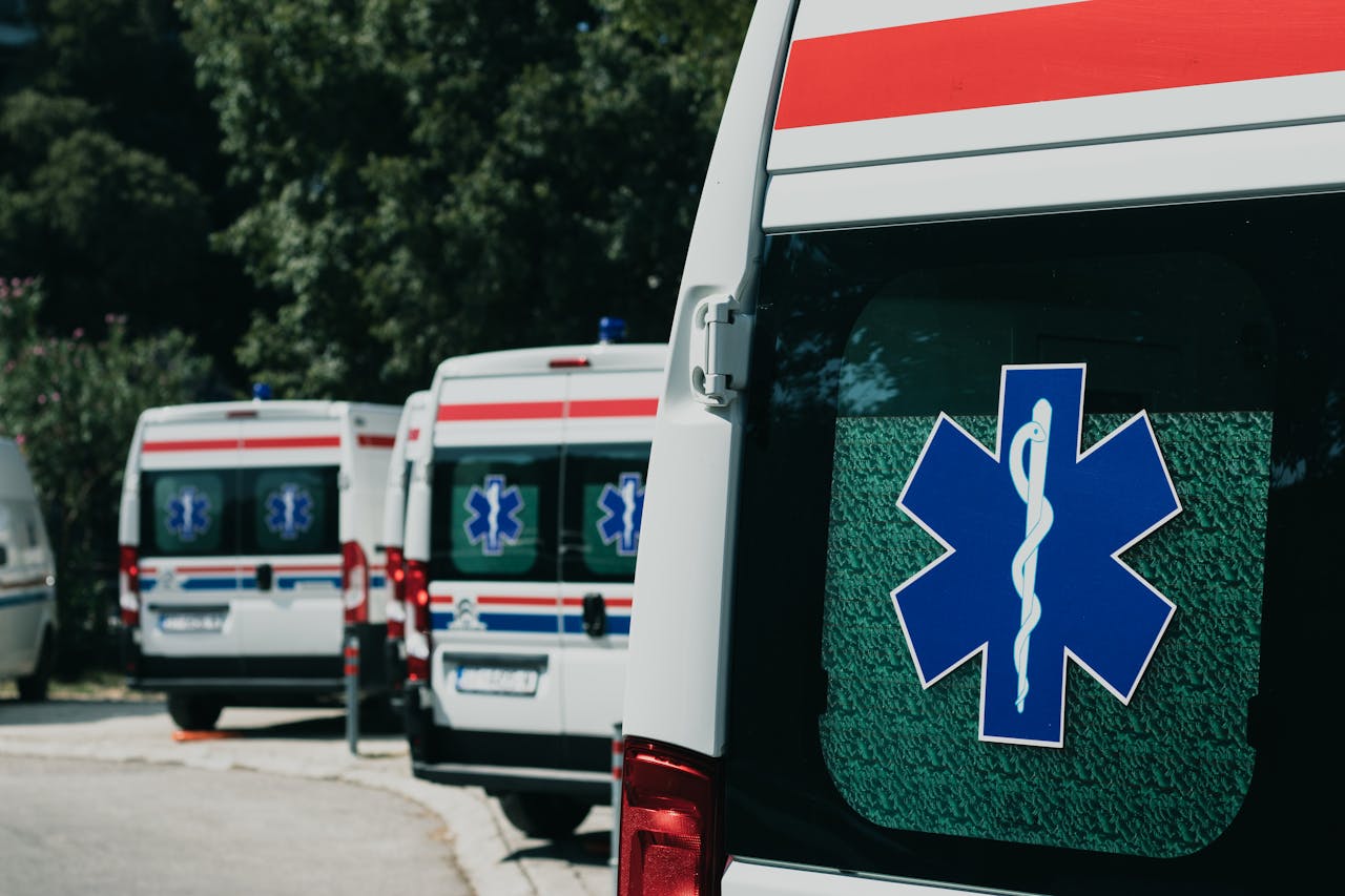 Three ambulances parked outdoors, ready for emergency healthcare situations.